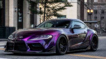 Fioletowa Toyota Supra zaparkowana na miejskiej ulicy wśród wysokich budynków